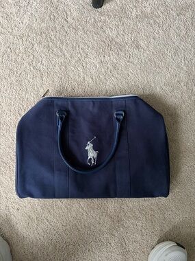 Navy and silver polo Ralph Lauren duffel bag. Comes with strap.